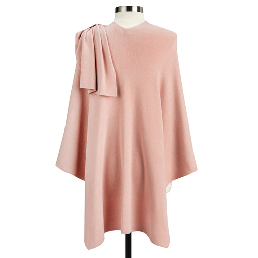 Pink poncho with a knot detail on a mannequin against a white background