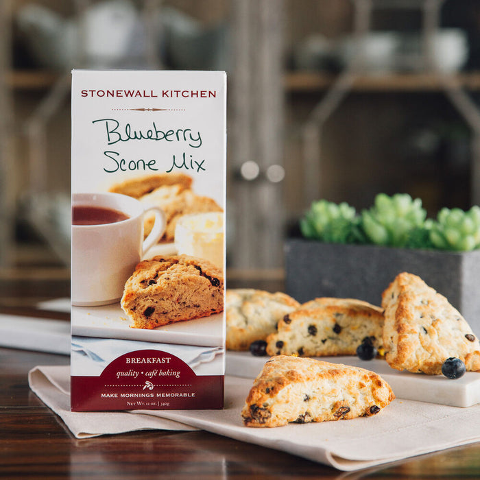 Stonewall Kitchen Blueberry Scone Mix packaging with scones on a table.