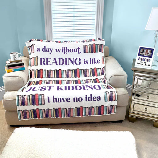 Sofa with a blanket featuring book-themed text in a living room setting.