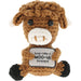 A brown crocheted plush cow toy holding a sign that reads 'keep calm & MOO-VE forward'. The toy has a white snout and ears, black eyes, black hooves, and is photographed against a solid white background.