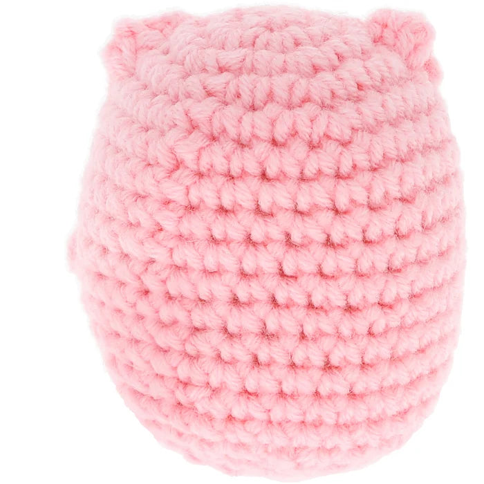 Pink crocheted item on a white background