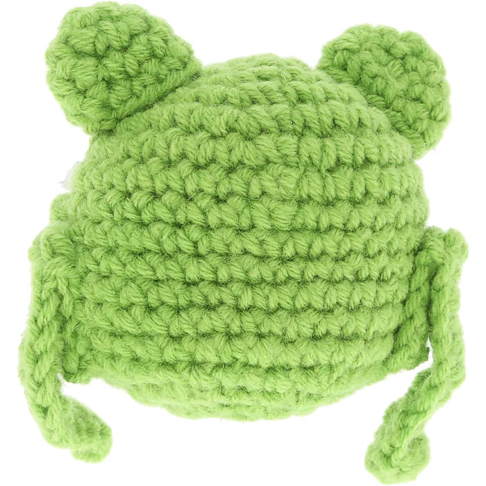 Green knitted frog hat on a white background