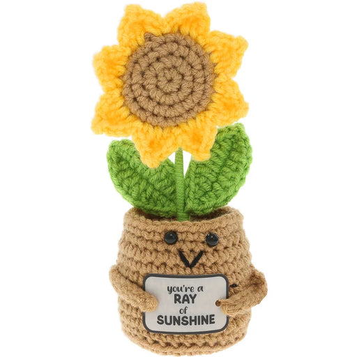 Crocheted sunflower in a pot with a message tag on a white background