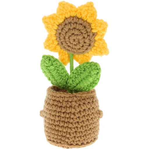 Crocheted sunflower in a pot on a white background