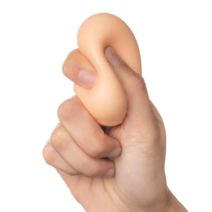 Hand holding a beige-colored stress ball against a white background