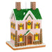 Decorative gingerbread house ornament with green roof and pink walls on a white background