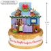 Decorative Christmas village scene with a house, bed, and characters, featuring measurements and a power cord sold separately text.