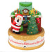 Decorative Christmas ornament with Santa Claus, tree, and fireplace.