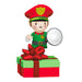Elf security guard figurine with red hat and green outfit on a gift box with a flashlight.
