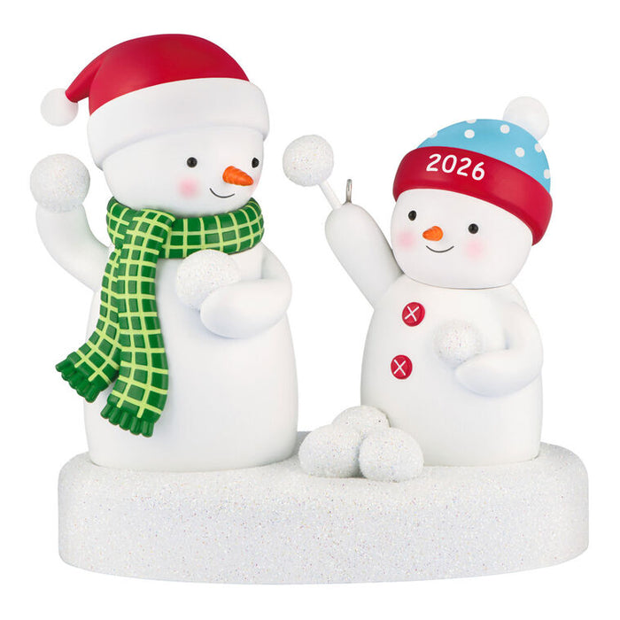 Two snowman figurines with festive hats and scarves on a white background