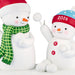 Two snowman figurines, one with a green scarf and red hat, the other with a blue and red hat labeled '2026'.