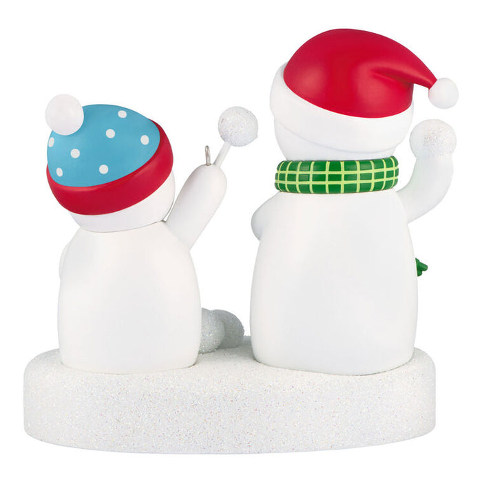 Two snowman figurines with colorful hats and scarves on a white background