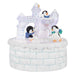 Decorative ice castle ornament with penguins on a white background