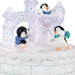 Penguin figurines with scarves on a snowy base