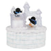 Decorative ice sculpture castle with penguins on a white background