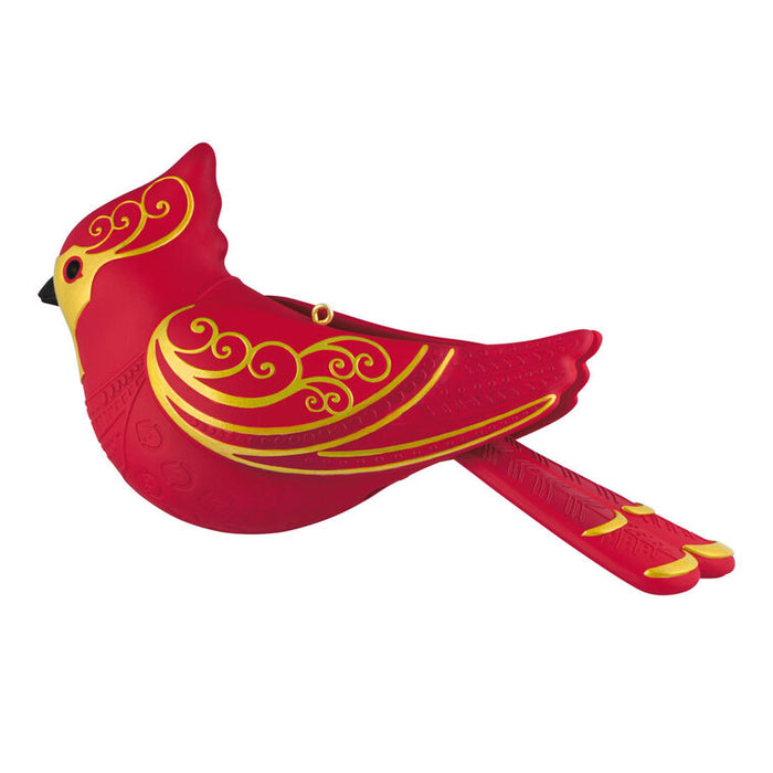 Red cardinal with gold patterns on a white background