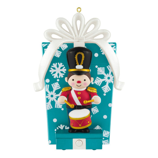 Christmas ornament with a toy soldier on a blue box with snowflake pattern