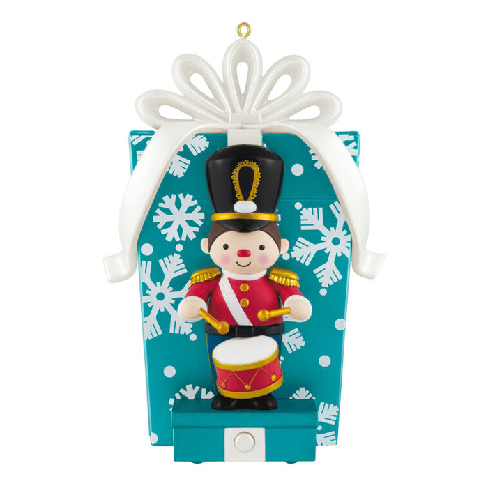 Christmas ornament with a toy soldier on a blue box with snowflake pattern