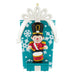 Christmas ornament with a toy soldier on a blue box with snowflake pattern