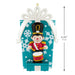 Christmas ornament of a toy soldier with drum on a decorative box, showing measurements.