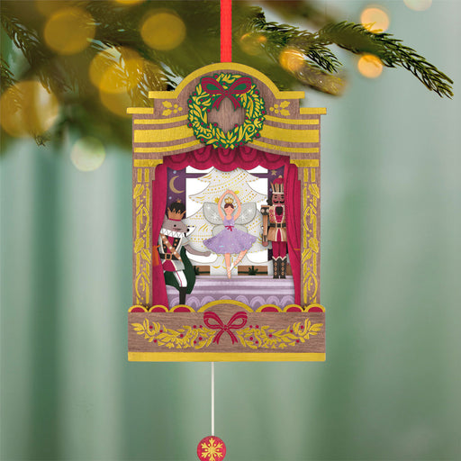 Decorative Christmas ornament with a Nutcracker scene on a green blurred background
