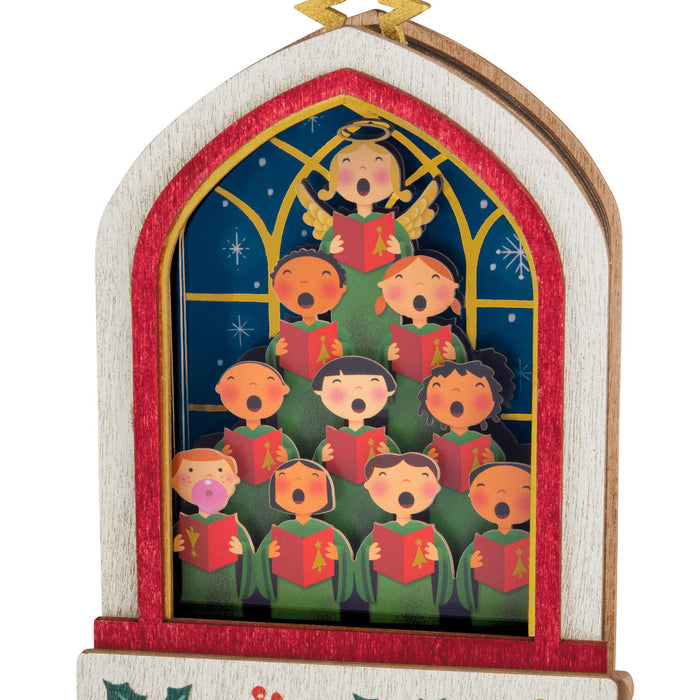 Decorative Christmas ornament with a choir of children singing in a stained glass window design.