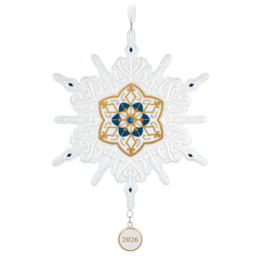Decorative snowflake ornament with gold and blue design on a white background