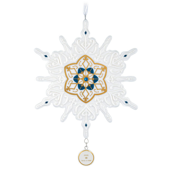 Decorative snowflake ornament with gold and blue design on a white background