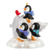 Ornament with penguins and a bird on a snowy base with an ice sculpted tree
