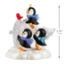 Decorative penguin figurine with a bird on a white background