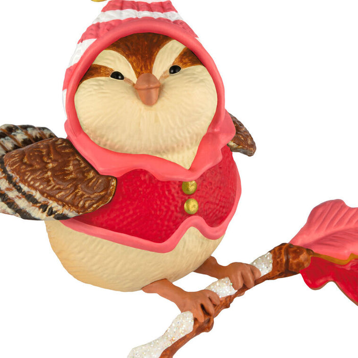 Bird figurine wearing a red outfit with a hat on a white background