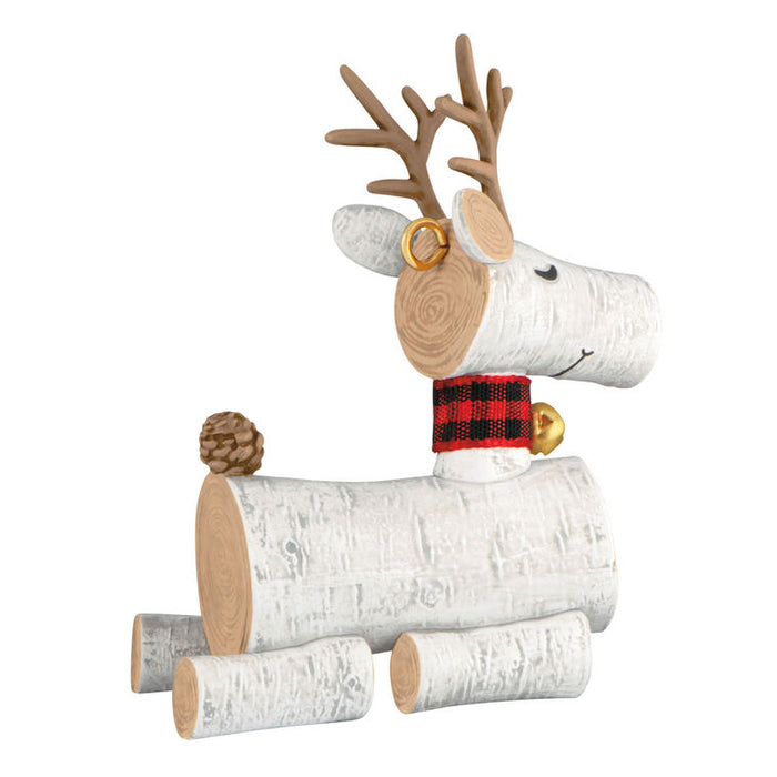 Decorative reindeer made of logs with a plaid scarf on a white background