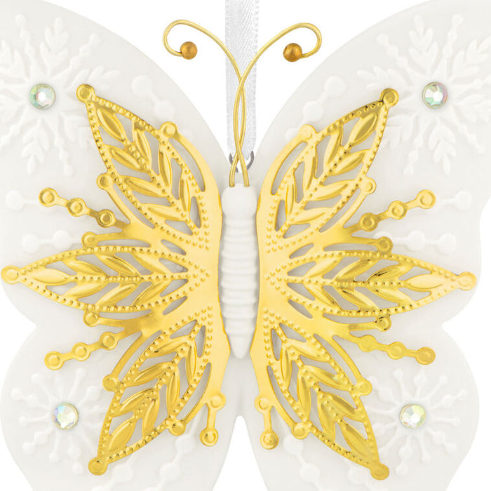 White and gold butterfly design on a white background