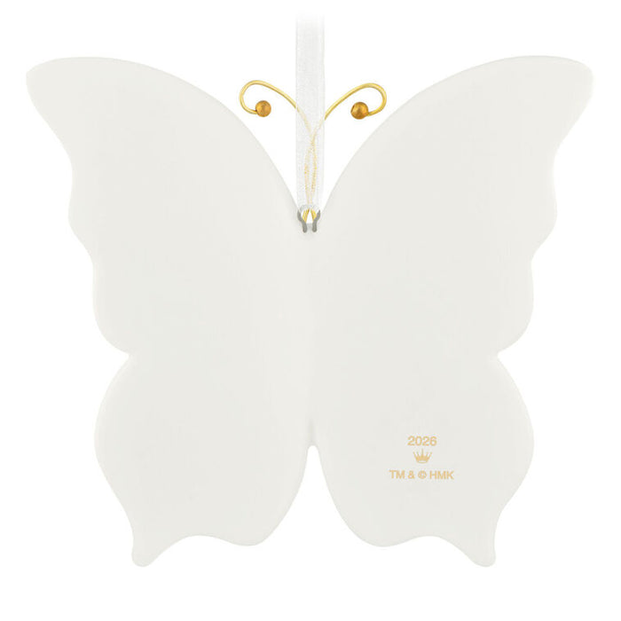 White butterfly-shaped ornament with gold accents on a white background
