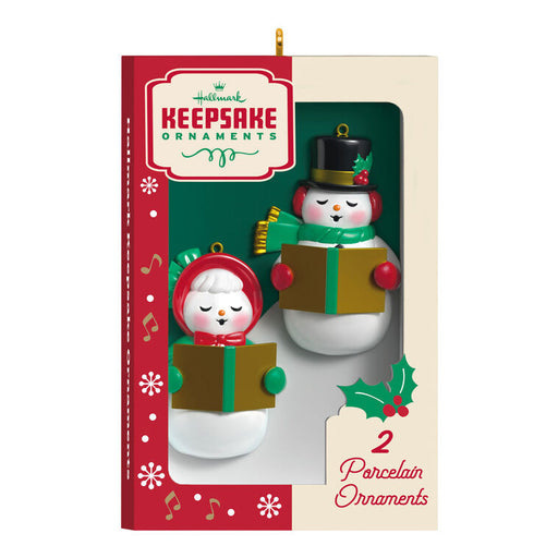 Two snowman ornaments in a 'Hummel Keepsake Ornaments' box on a white background
