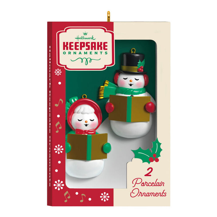 Two snowman ornaments in a 'Hummel Keepsake Ornaments' box on a white background