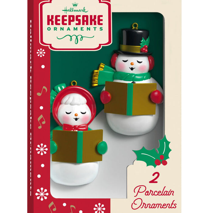 Two snowman ornaments in a vintage Hallmark packaging with a red and green design.