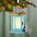 Decorative birdhouse with birds ornament on a Christmas tree