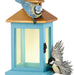 Blue birdhouse with two birds on a white background