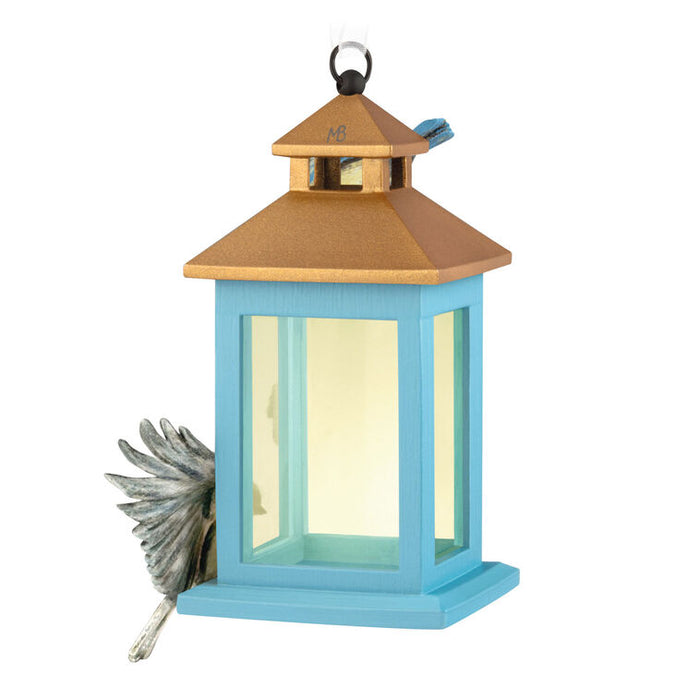 Blue and gold birdhouse on a white background