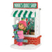 Ornament of a girl holding a teddy bear in front of Nikki's Quilt Shop