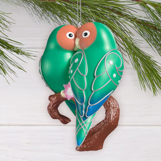 Decorative bird ornament on a branch with a white background