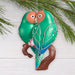 Decorative bird ornament on a branch with a white background