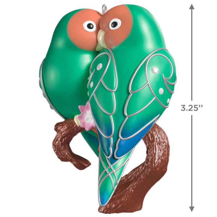 Decorative ornament of two green birds on a branch with a measurement label.