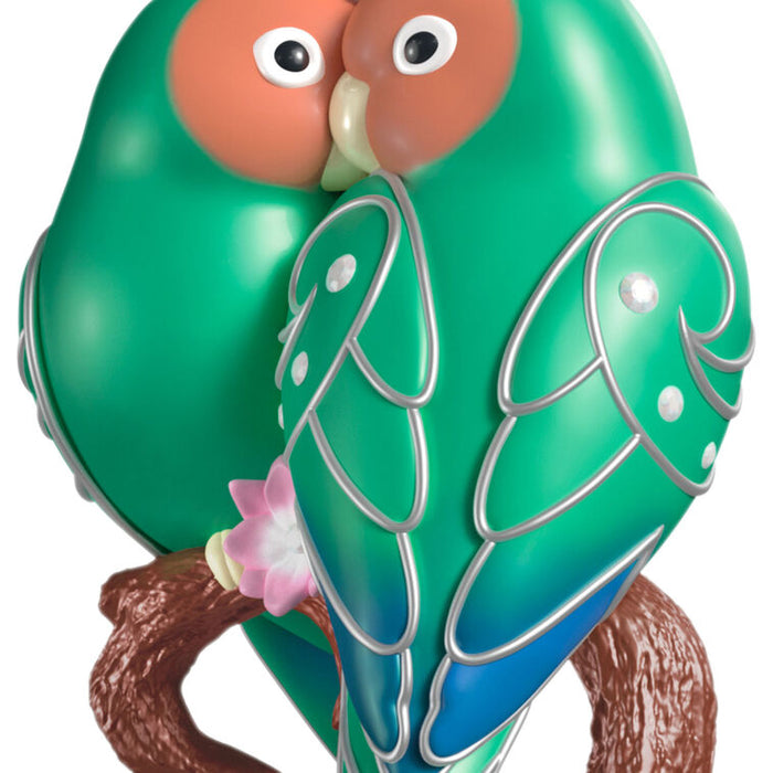 Colorful birds figurine on a branch with a white background