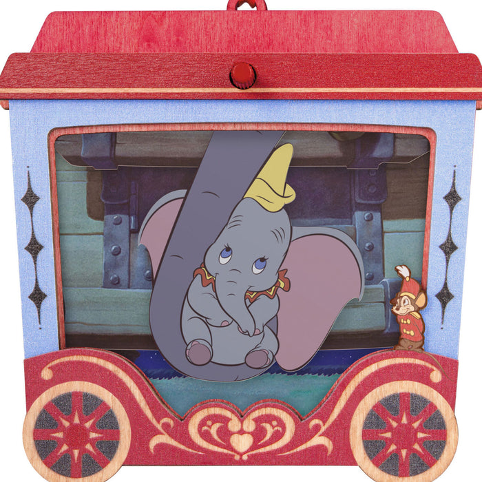 Toy carriage with Dumbo and Timothy Q. Mouse inside, featuring a red roof and decorative wheels.