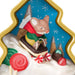 Decorative Christmas ornament with a mouse sledding on a cookie, surrounded by candy and snowflakes.