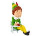 Christmas ornament of an elf sitting on a chair with a book and apple, wearing a green outfit with a green and yellow hat.