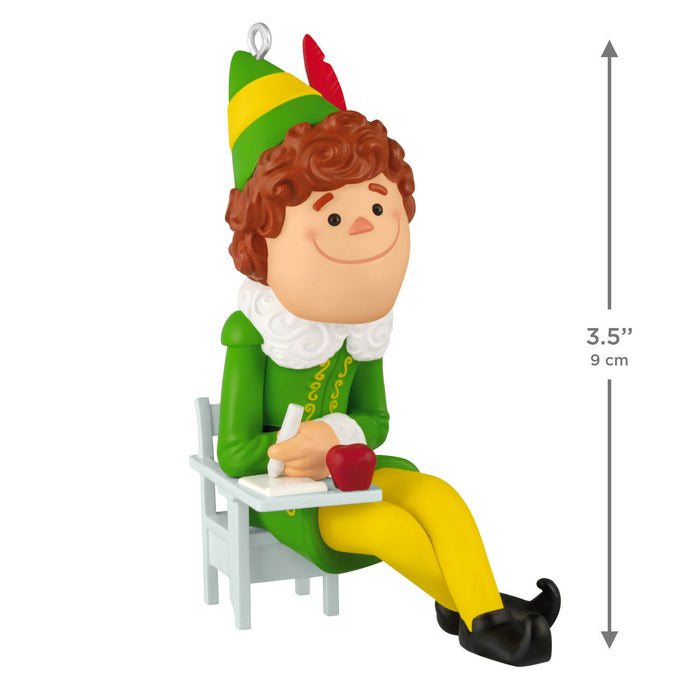 Elf figurine with a green hat and yellow hat, green outfit, yellow pants, sitting on a chair with an apple and pen, on a white background.