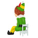 Elf ornament sitting on a chair with a white background